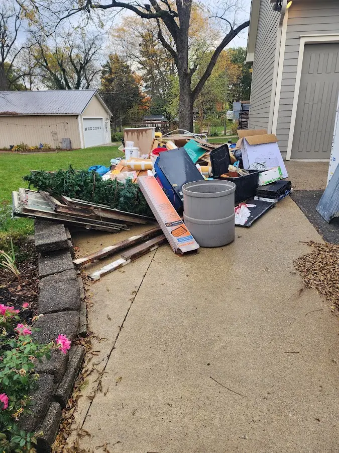 Dumpster being loaded with debris for Estate Cleanout Dumpster Rental in Preston